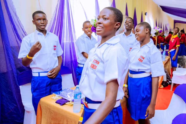 Celebrating friendship and success: Secondary school students share a joyful moment together at their tables during the event.