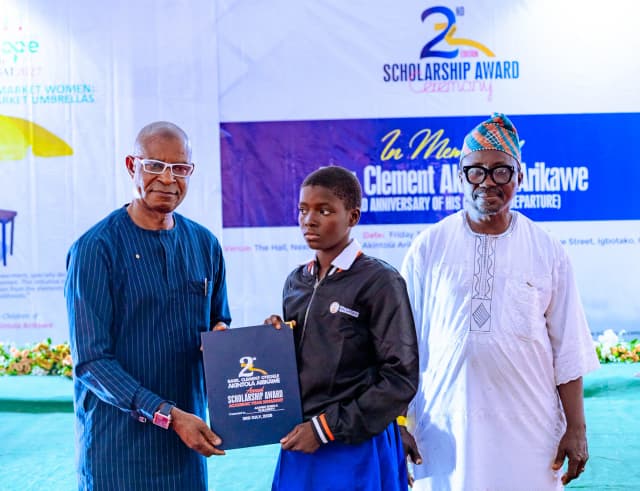 Encouraging girl-child education: A female scholar receives her award on stage at the Igbotako ceremony.