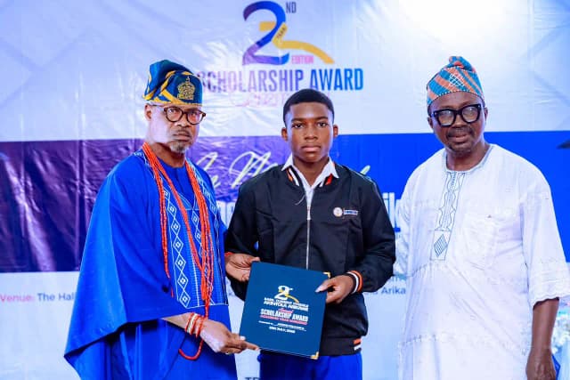Fostering academic growth: Trustees hand over the 2026 scholarship package to a promising secondary student on stage.