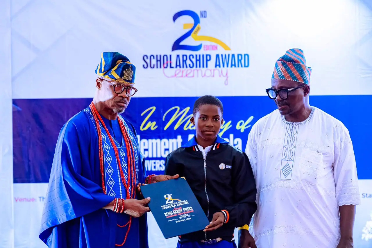 A milestone of achievement: An awardee stands with Akintola Arikawe family trustees and educational officials during the certificate presentation.